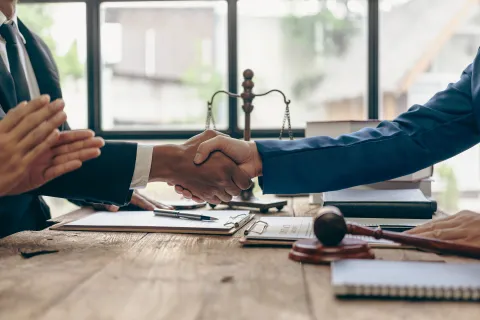 Two people shake hands